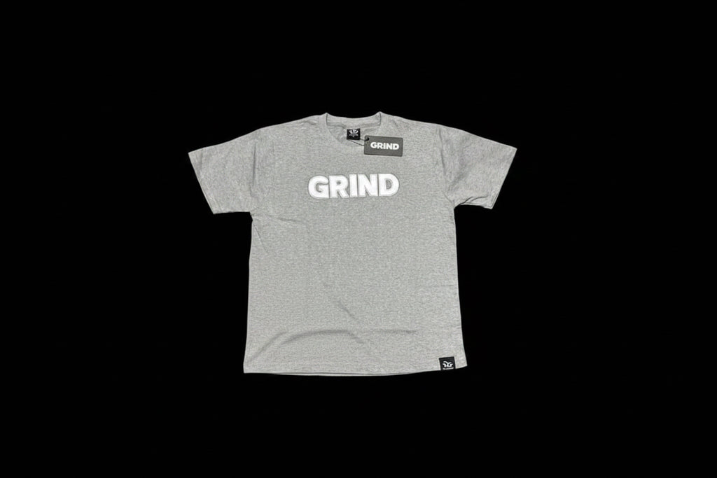 Gray t-shirt and shorts with 'GRIND' text on a green grass-like surface