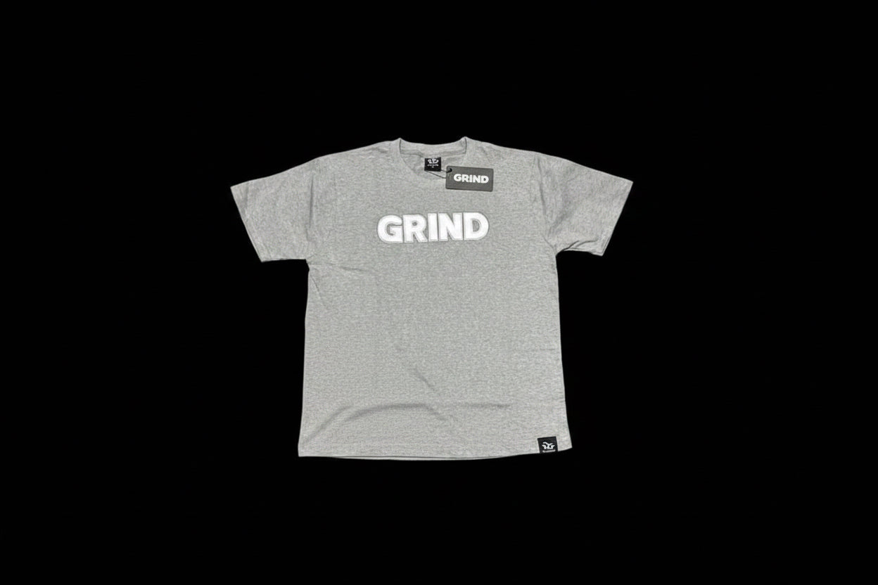 Gray t-shirt and shorts with 'GRIND' text on a green grass-like surface